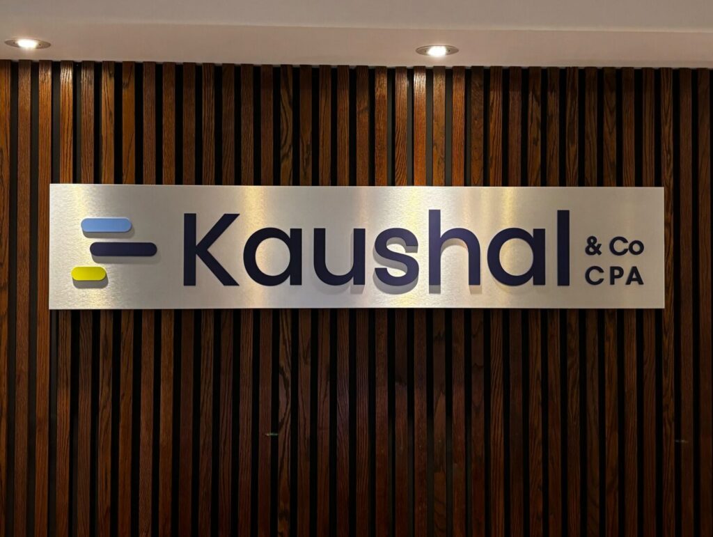 Custom aluminum-backed dimensional reception sign installed for Kaushal. Interior office signage designed to create a professional and modern branded entrance.