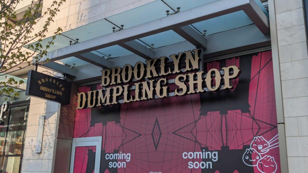 Custom channel letters, hoarding graphics, and blade sign installed for Brooklyn Dumpling. Complete storefront signage solution designed for restaurant branding and visibility.
