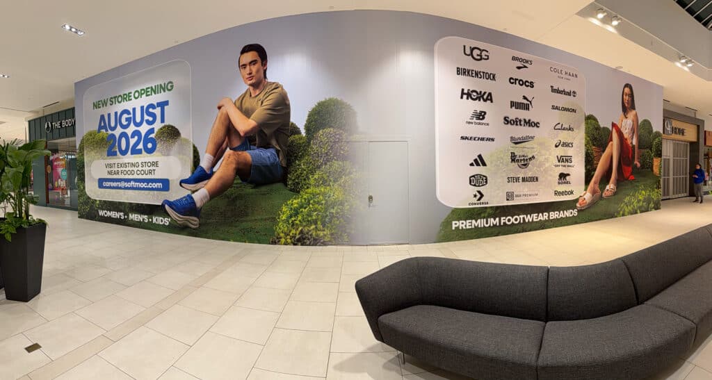 Large-format printed mall hoarding graphics installed for SoftMoc. Custom retail signage designed for high-visibility branding and promotional displays.